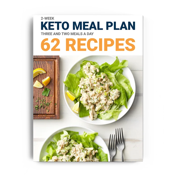 Dr. Berg's 2-week Keto Meal Plan: Digital version with 62 recipes. Cover shows two plates of chicken salad lettuce wraps, sliced lemons, a cutting board, and two forks.