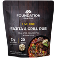 Foundation Pantry Live Fire Fajita and Grill Rub, stand-up pouch with four seasoning packets, front view featuring a meat dish with vegetables and lime.